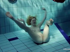 LibertyPorno presents: Blonde goes for a swim and strips