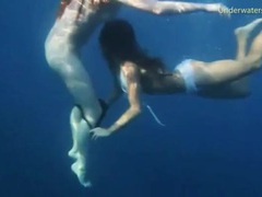 LibertyPorno presents: Bikini girls swim in the ocean and strip