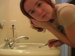 LibertyPorno presents: Redhead in tee shirt does her makeup